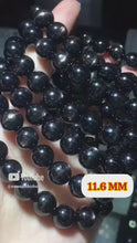 將影片載入圖庫檢視器並播放，本段影片完整展示煉域極級金運石手鍊 11.6MM 18粒的黑色色澤與晶體細節
